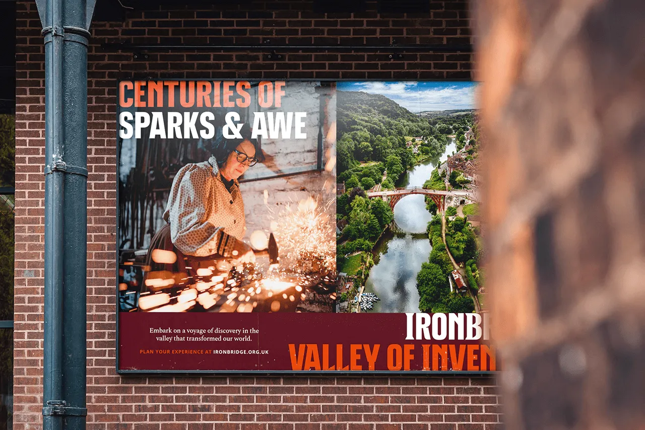 Billboard promoting Ironbridge Valley of Invention, with a caption saying "Centuries of Sparks & Awe"
